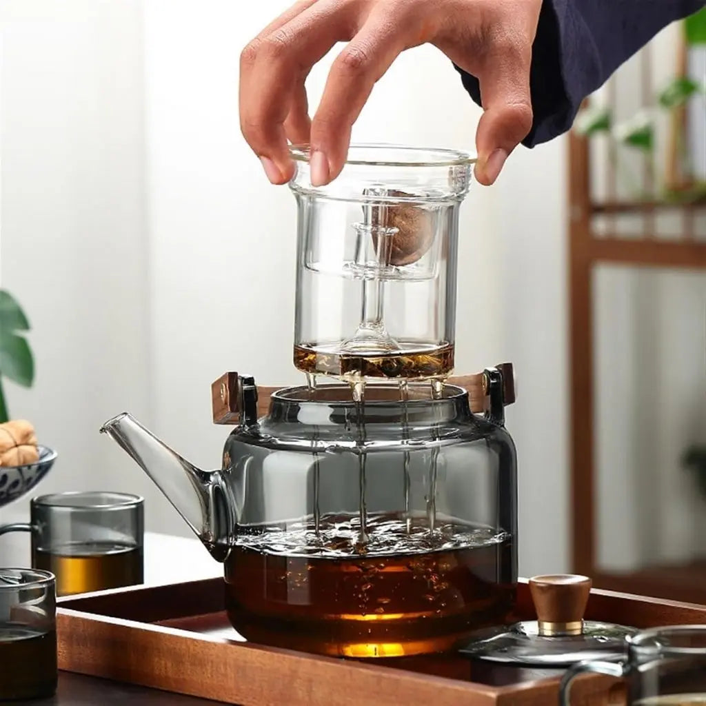 Heat-resistant glass teapot with wooden handle ideal for serving multiple cups of freshly brewed loose leaf tea