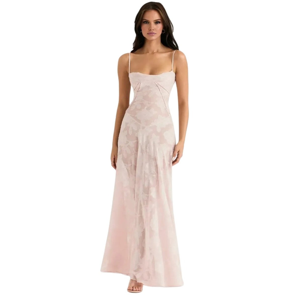 Woman wearing a long, light pink Kouvr dress on a white background