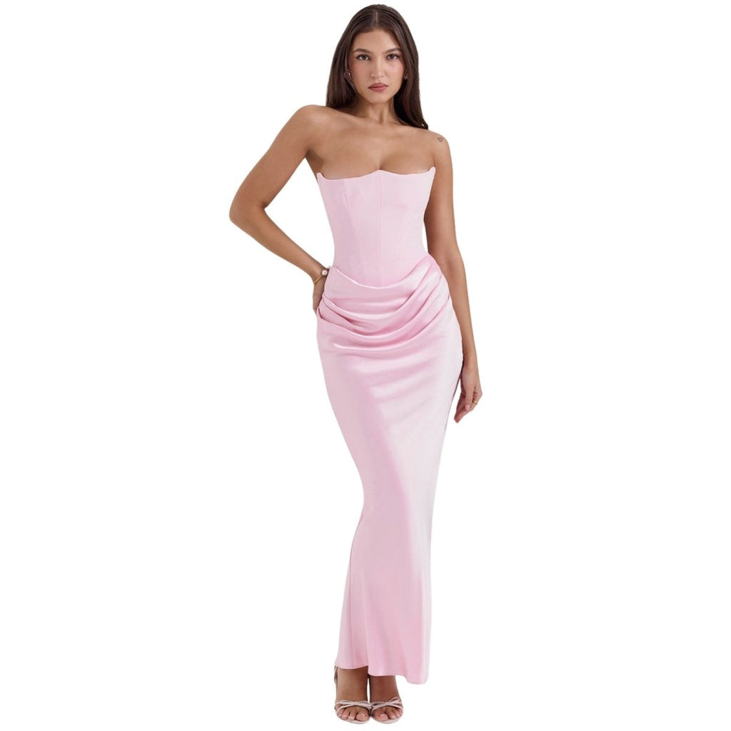 Woman wearing a strapless pink Kouvr dress on a white background