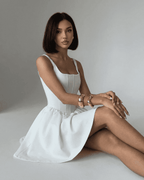 Alba Mini Dress by Lauven, pure white structured corset mini dress with square neckline, showcasing a tailored silhouette.