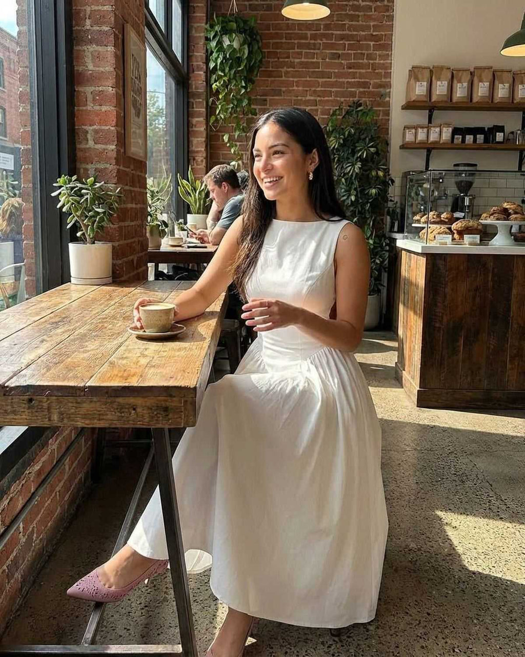 Elysia Midi Dress by Lauven, elegant A-line sleeveless dress captured in a cozy café setting.
